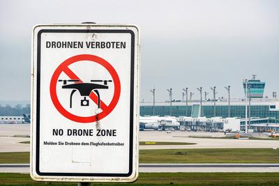 Munich, Bavaria, Germany - October 3, 2025: Photo montage, drone prohibition sign in front of Munich Airport (background-stock-foto