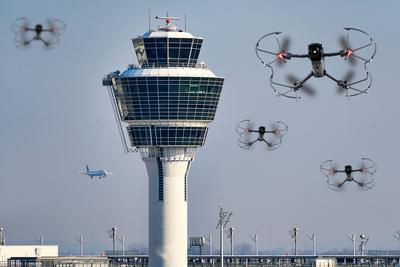 Munich, Bavaria, Germany - October 3, 2025: Photo montage, several drones flying in front of the control tower at Munich-stock-foto