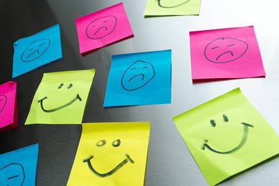 Germany September 27, 2025: Colorful Post-it notes with smiling and sad smileys symbolize a rollercoaster of emotions go-stock-foto