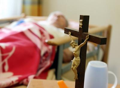 Kruzifix auf dem Nachttisch eines Altehheim-Bewohners (gestelltes Themenfoto). Eine Gruppe von zehn Abgeordneten des Bu-stock-foto