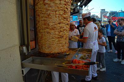Employees prepare traditional street food for customers in front of a small restaurant in Istanbul, Turkey, on Saturday,-stock-foto