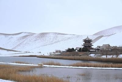 DUNHUANG, CHINA - NOVEMBER 23: A view of the scenery of the Mingsha Mountain and Crescent Spring Scenic Area after a sno-stock-foto