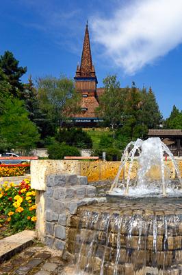 Miskolc, szökőkút a Petőfi téren (háttérben a Deszkatemplom)-stock-photo