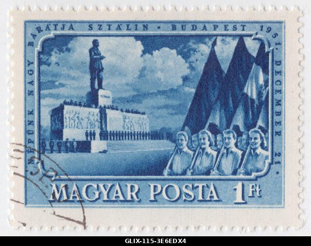 HUNGARY - 1951  December 16: 1 forint deep blue postage stamp depicting a crowd marches past the monumental Stalin monument in Budapest to mark Jos...