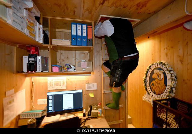Munich, Germany. 27th Sep, 2026. Festival host Christian Schottenhamel climbs a ladder in the Schottenhamel festival hall to reach his sleeping box...