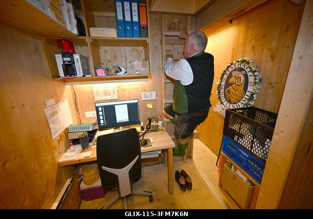 Munich, Germany. 27th Sep, 2026. Festival host Christian Schottenhamel climbs a ladder to his sleeping box in the Schottenhamel festival hall. The...